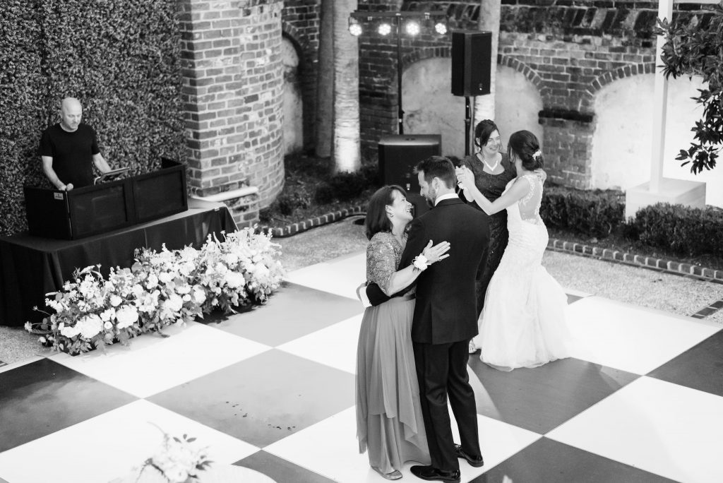 groom and mother and bride and mother dance at wedding reception