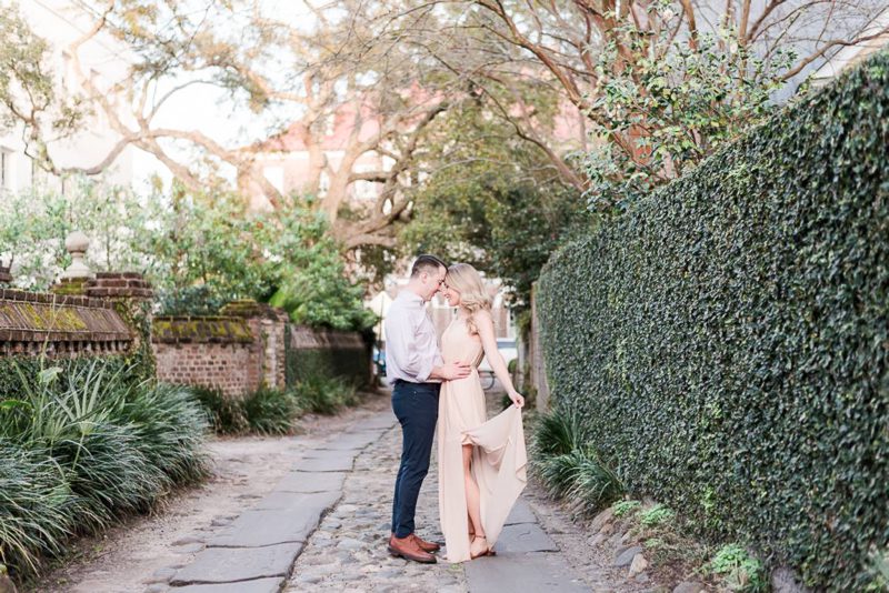 couple forehead to forehead in an alley