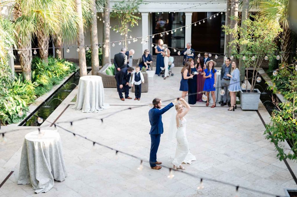 newlyweds first dance in outdoor courtyard at Cannon Green