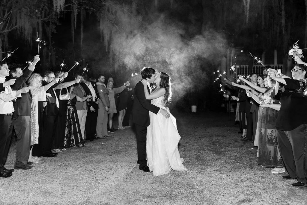 newlyweds kiss during wedding sparkler exit