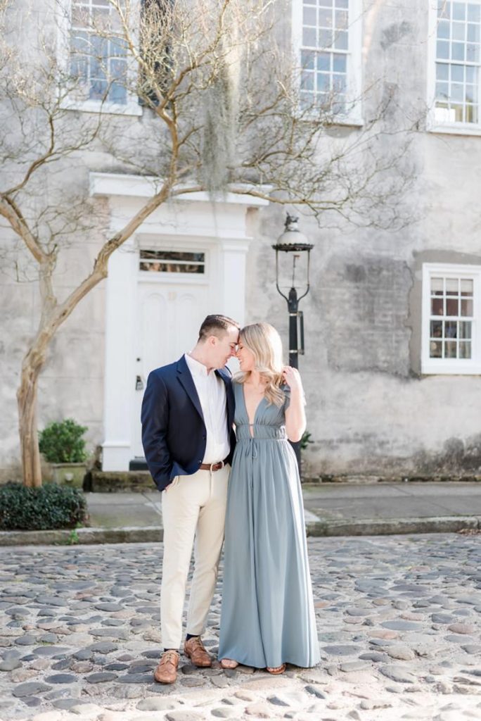 couple forehead to forehead on cobblestone road