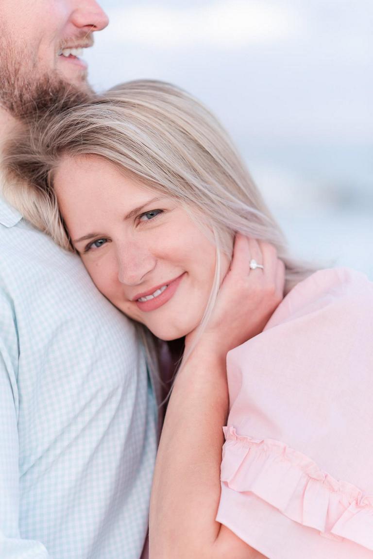 Close up of girl holding hair back, engagement ring showing