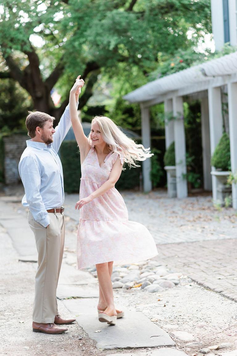Guy twirls his fiancée wearing pink dress