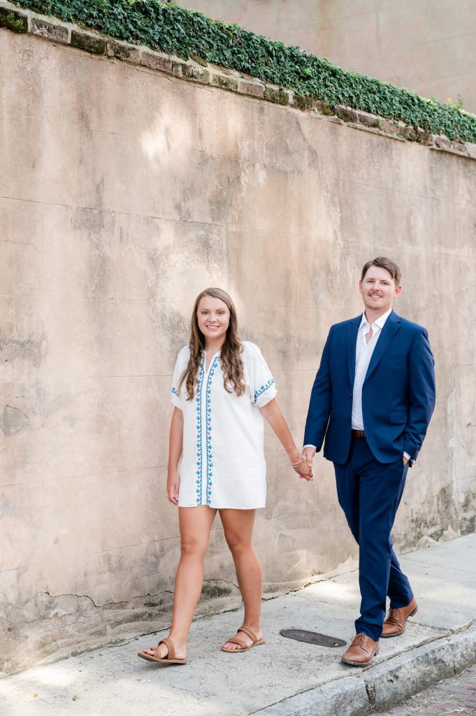 engaged couple walk hand in hand on Church Street