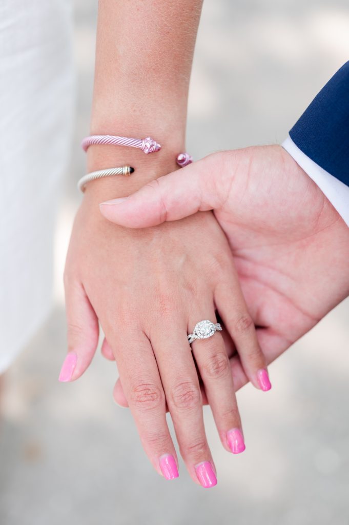 close up of couple's hands showing off new engagement ring