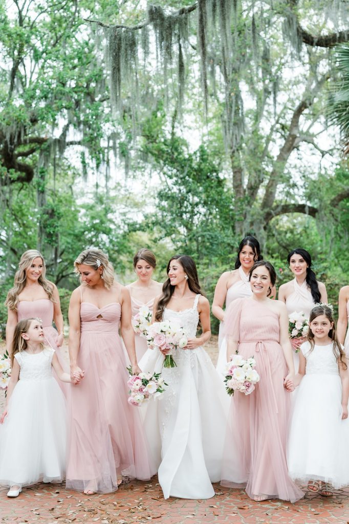 bride and her bridesmaids walking in garden