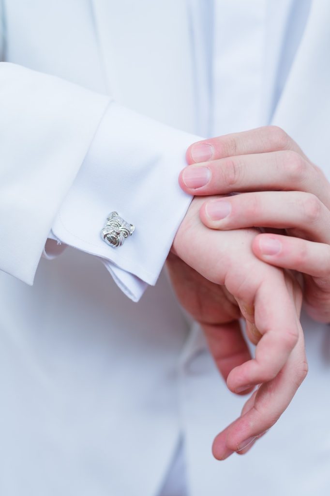close up of groom's silver bulldog cufflinks