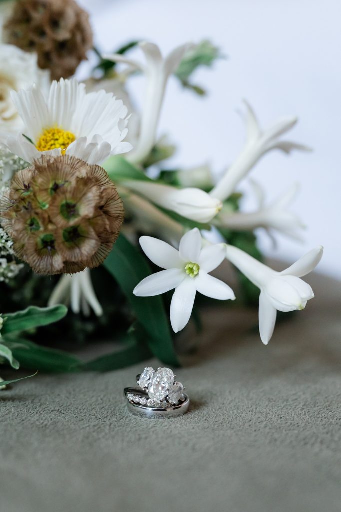 wedding ring closeups with flowers in n=background