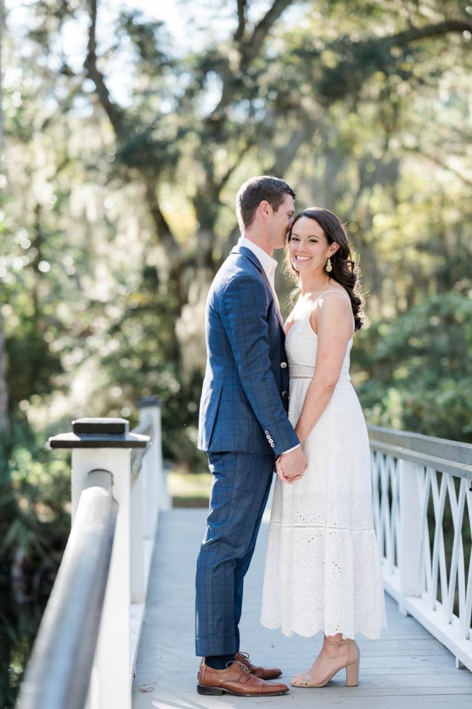 couple holds hands on infamous white bridge at Magnolia Plantation