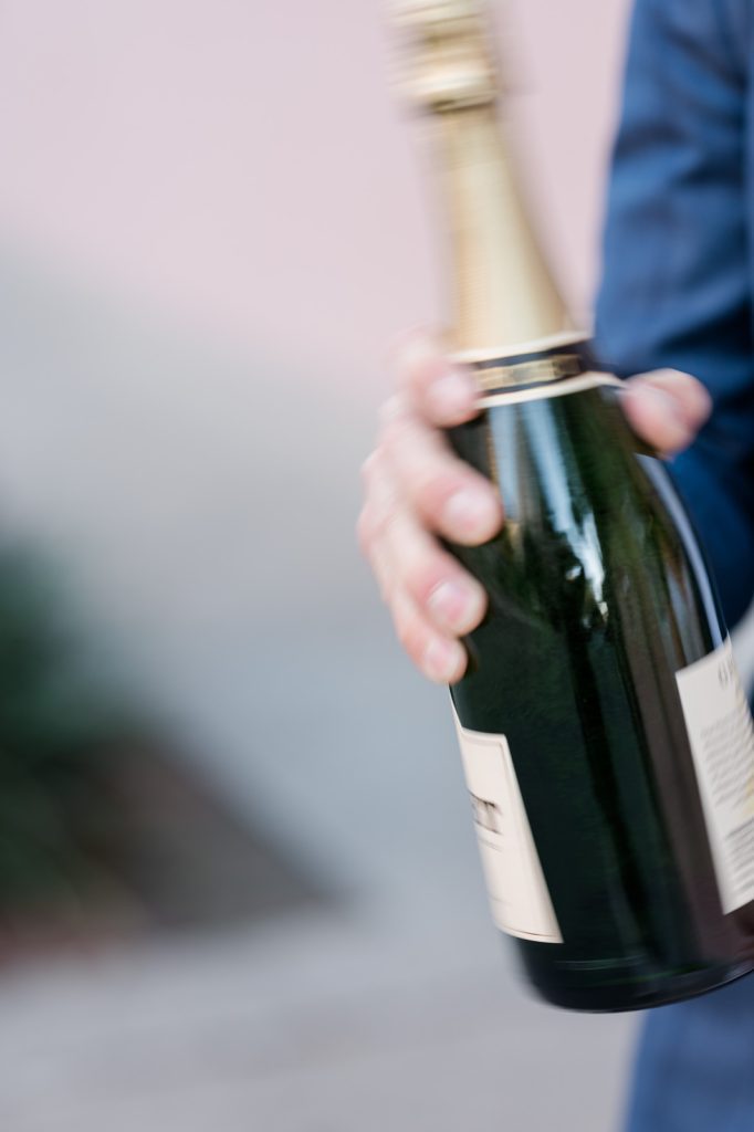 blurry close up of bottle of champagne being shook up