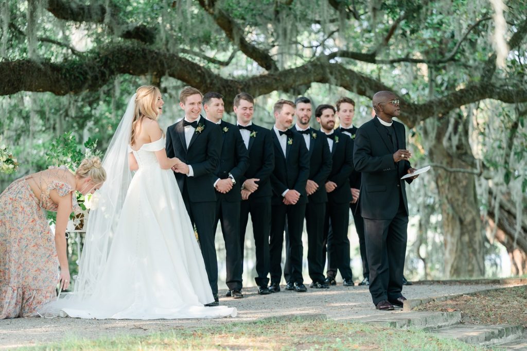 priest addresses wedding guests at wedding ceremony