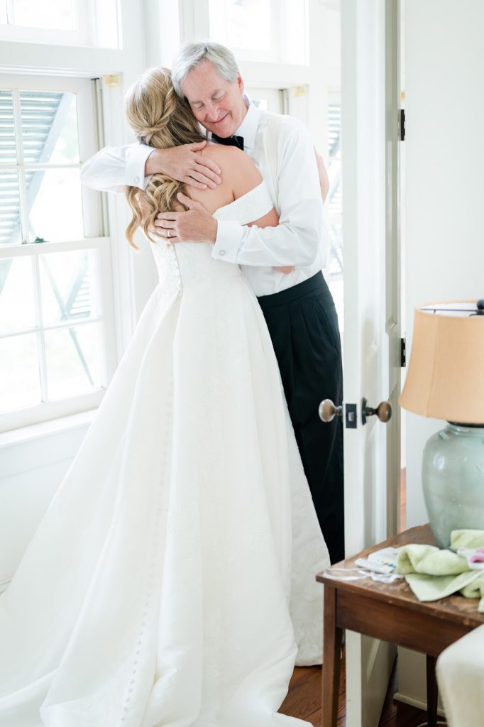 father of the bride hugs the bride after first look