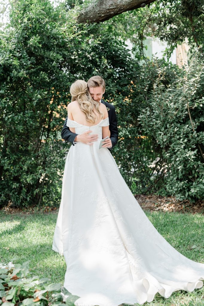 groom hugs bride after seeing her for the first time in wedding dress