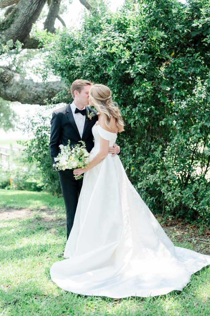 bride and groom kiss in garden
