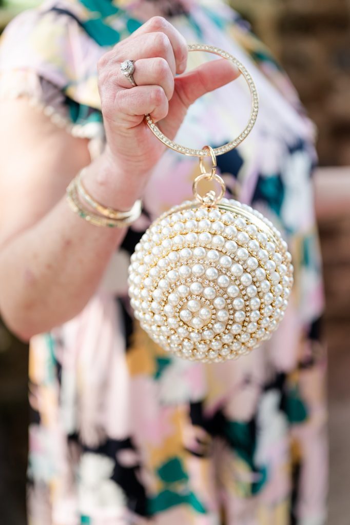 close up of sphere shaped purse studded with pearls