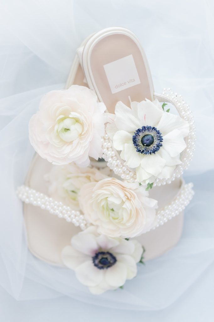 close up of wedding shoes with flowers