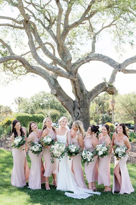 candid photo of bridal party and bride laughing and talking