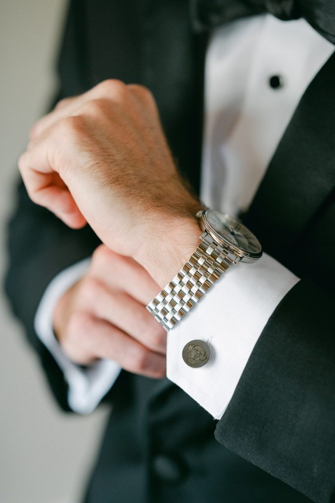 Groom tightening his watch on his wrist