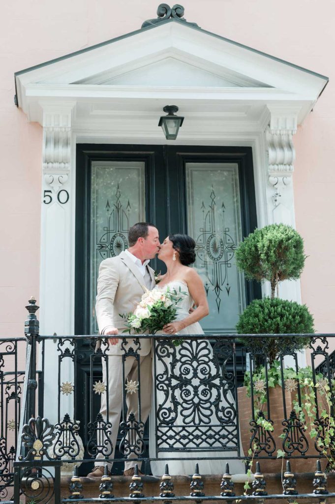 couple kiss on the front porch of the Parsonage