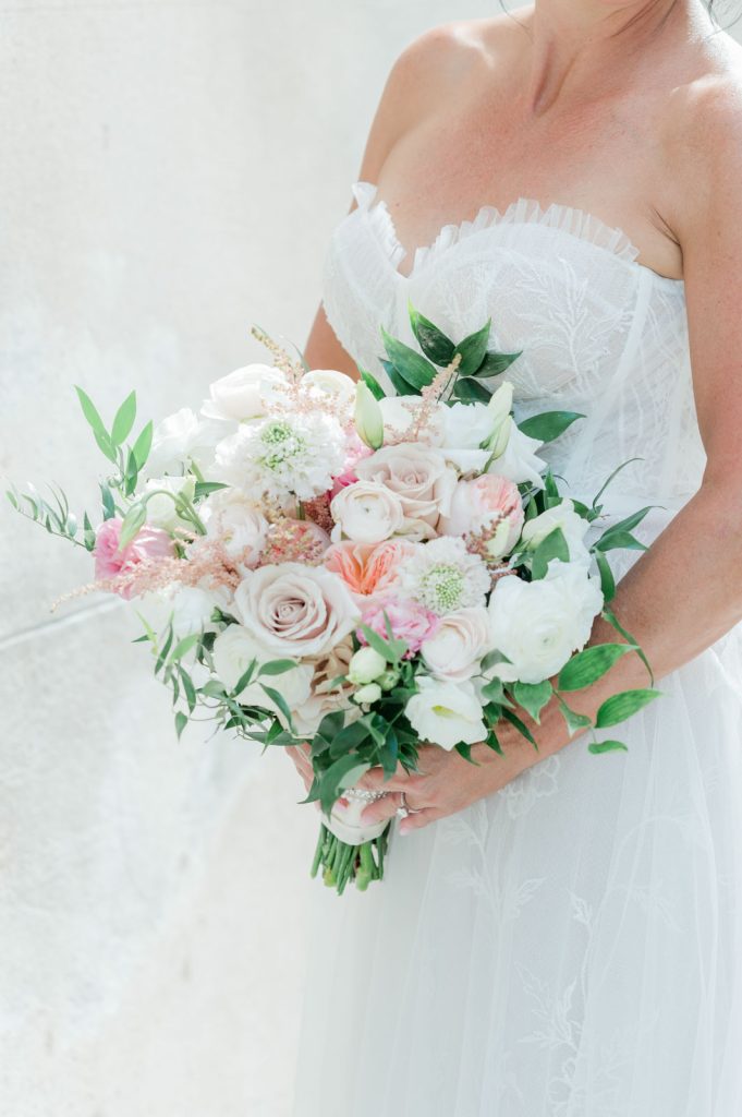 close up of bride holding pastel floral bouquet
