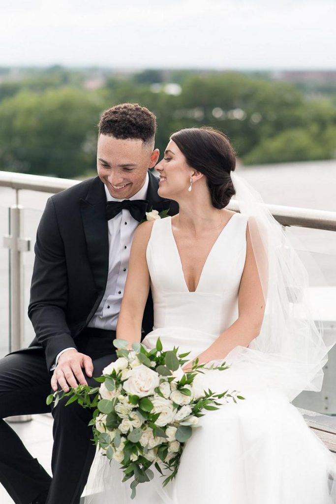 bride whispering into groom's ear