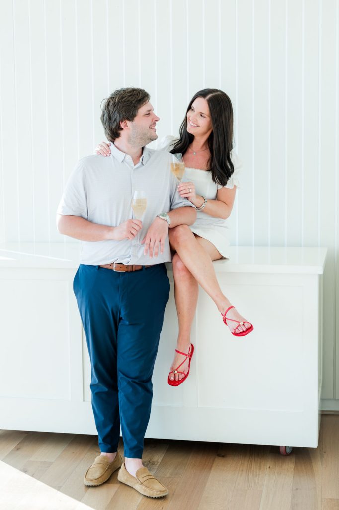 couple toasts new engagement with champagne flutes