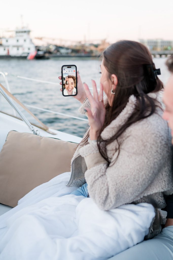bride showing mom engagement ring over her cell phone
